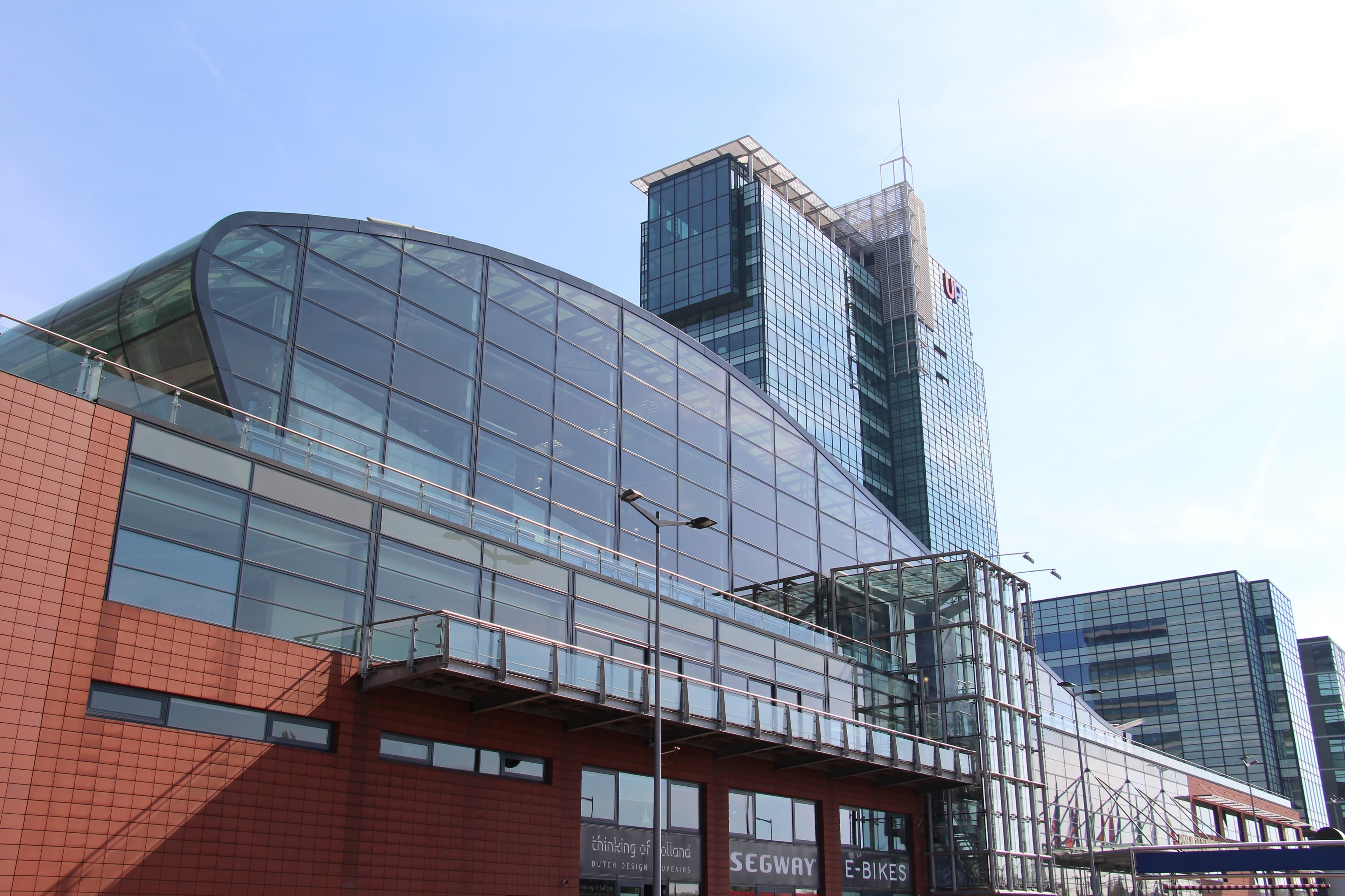 Passenger Terminal Amsterdam with a cruise ship docked on the IJ.