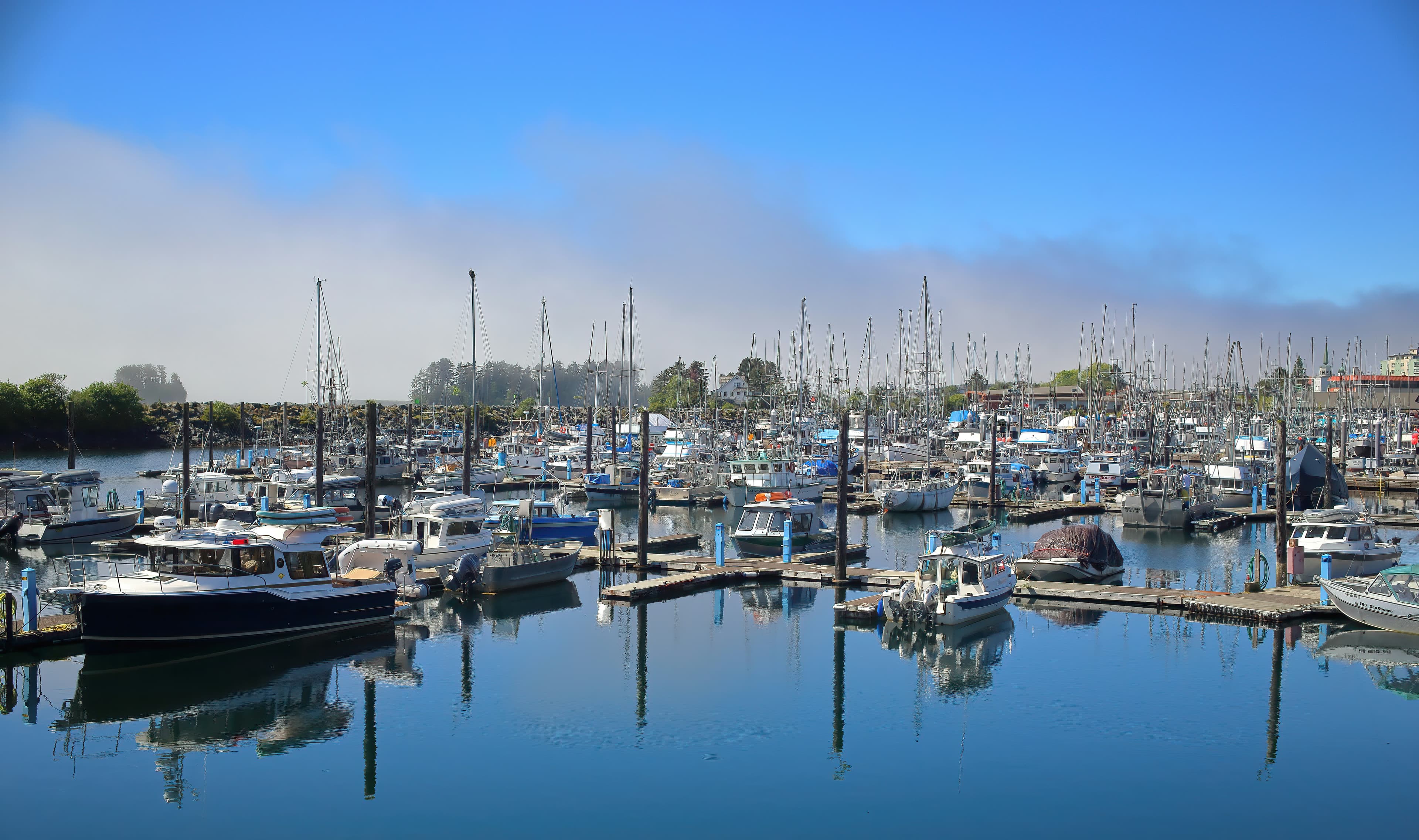 Small boats in Sitka Harbor on calm blue-gray water.